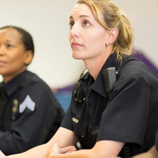 A police officer in a classroom